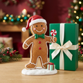 Christmas gingerbread man with Santa hat, green bow tie and peppermint detail beside plain emerald gift box